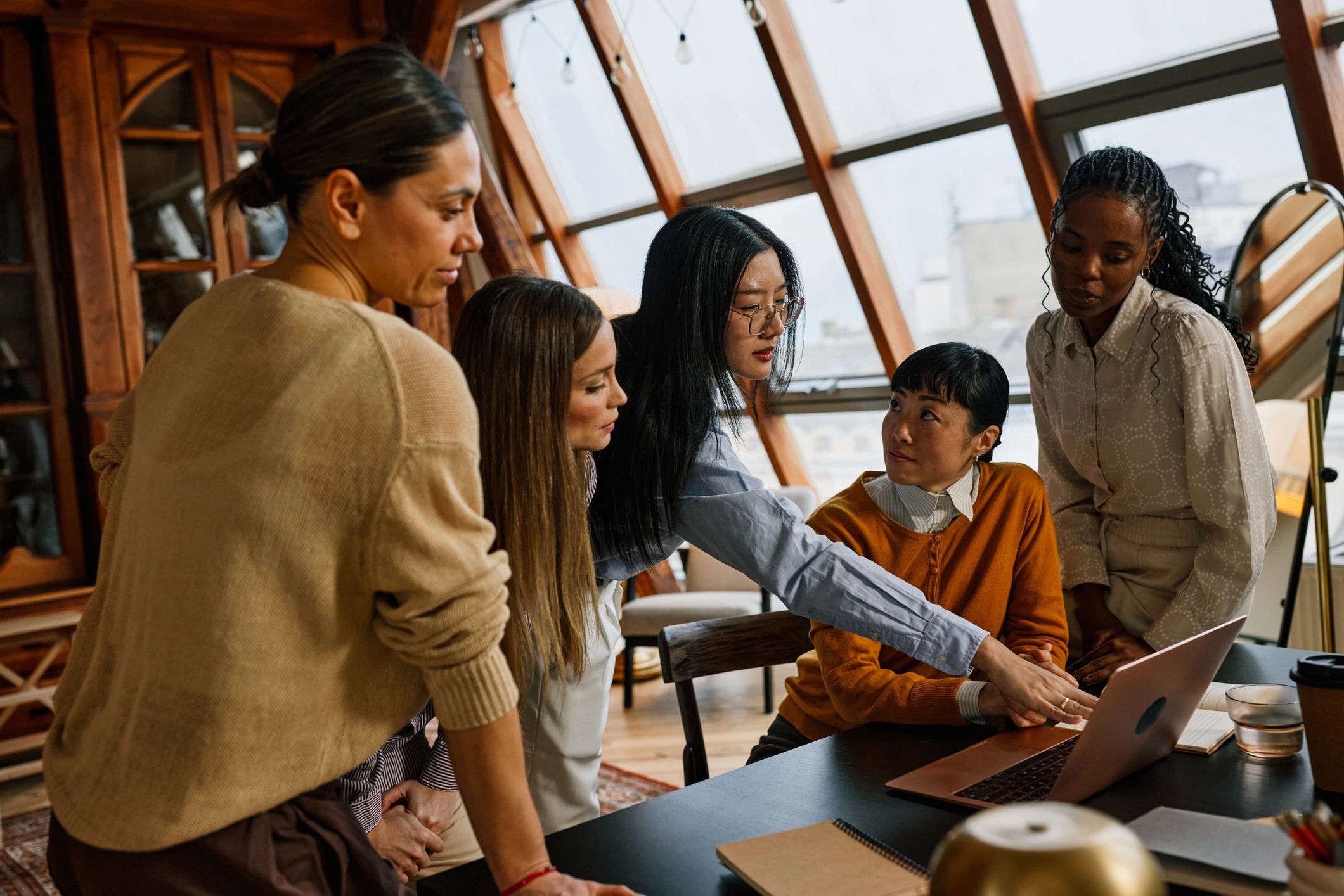 Team collaboration around a laptop in an office